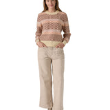 A woman wearing the Patagonia Women's Recycled Wool-Blend Crewneck Sweater - Starlight / Dark Natural available at Babipur.