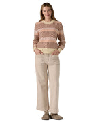 A woman wearing the Patagonia Women's Recycled Wool-Blend Crewneck Sweater - Starlight / Dark Natural available at Babipur.