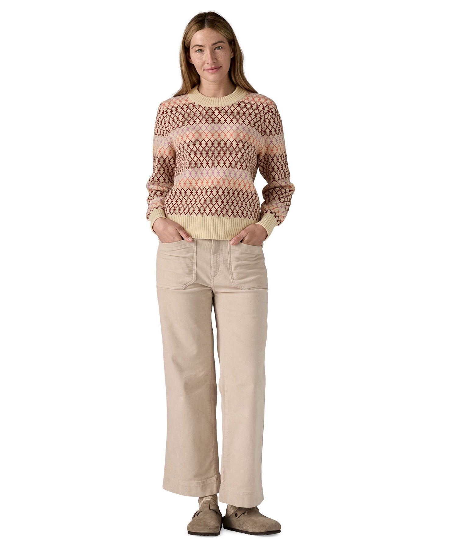 A woman wearing the Patagonia Women's Recycled Wool-Blend Crewneck Sweater - Starlight / Dark Natural available at Babipur.