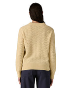 The back of a woman wearing the Patagonia Women's cream Recycled Wool-Blend Crewneck Sweater in chevron cable available at Babipur.