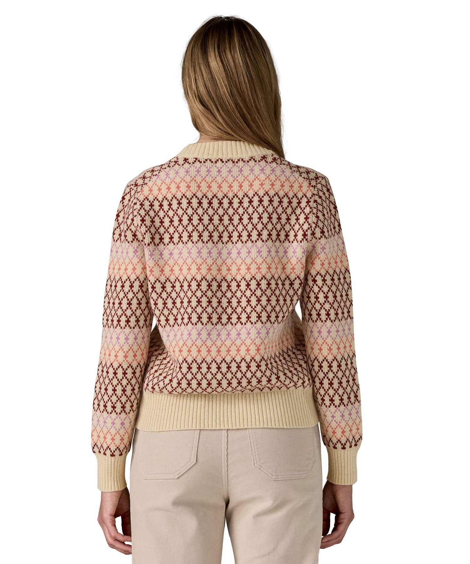 The back of a woman wearing the Patagonia Women's Recycled Wool-Blend Crewneck Sweater - Starlight / Dark Natural available at Babipur.