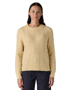 A woman wearing the Patagonia Women's Recycled Wool-Blend Crewneck Sweater - in dark natural colour available at Babipur.. A heavy knitted  jumper with a chevron style design 