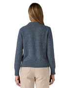 The back of a woman wearing the Patagonia Women's Recycled Wool-Blend Crewneck Sweater in dark blue with dappled design available at Babipur.