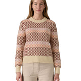 A woman wearing the Patagonia Women's Recycled Wool-Blend Crewneck Sweater - Starlight / Dark Natural. A heavy knitted patterned jumper with natural trim available at Babipur.