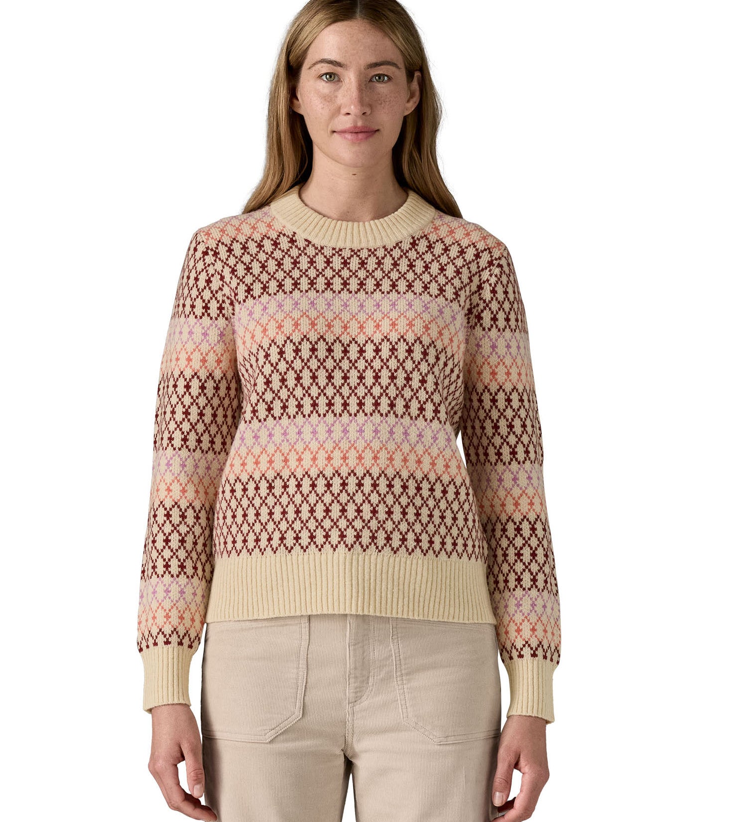 A woman wearing the Patagonia Women's Recycled Wool-Blend Crewneck Sweater - Starlight / Dark Natural. A heavy knitted patterned jumper with natural trim available at Babipur.