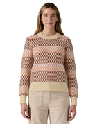 A woman wearing the Patagonia Women's Recycled Wool-Blend Crewneck Sweater - Starlight / Dark Natural. A heavy knitted patterned jumper with natural trim available at Babipur.