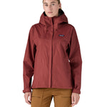 A person wearing the Patagonia Women's Torrentshell 3L Rain Jacket - Oxide Red, to show the fit of the jacket from the front