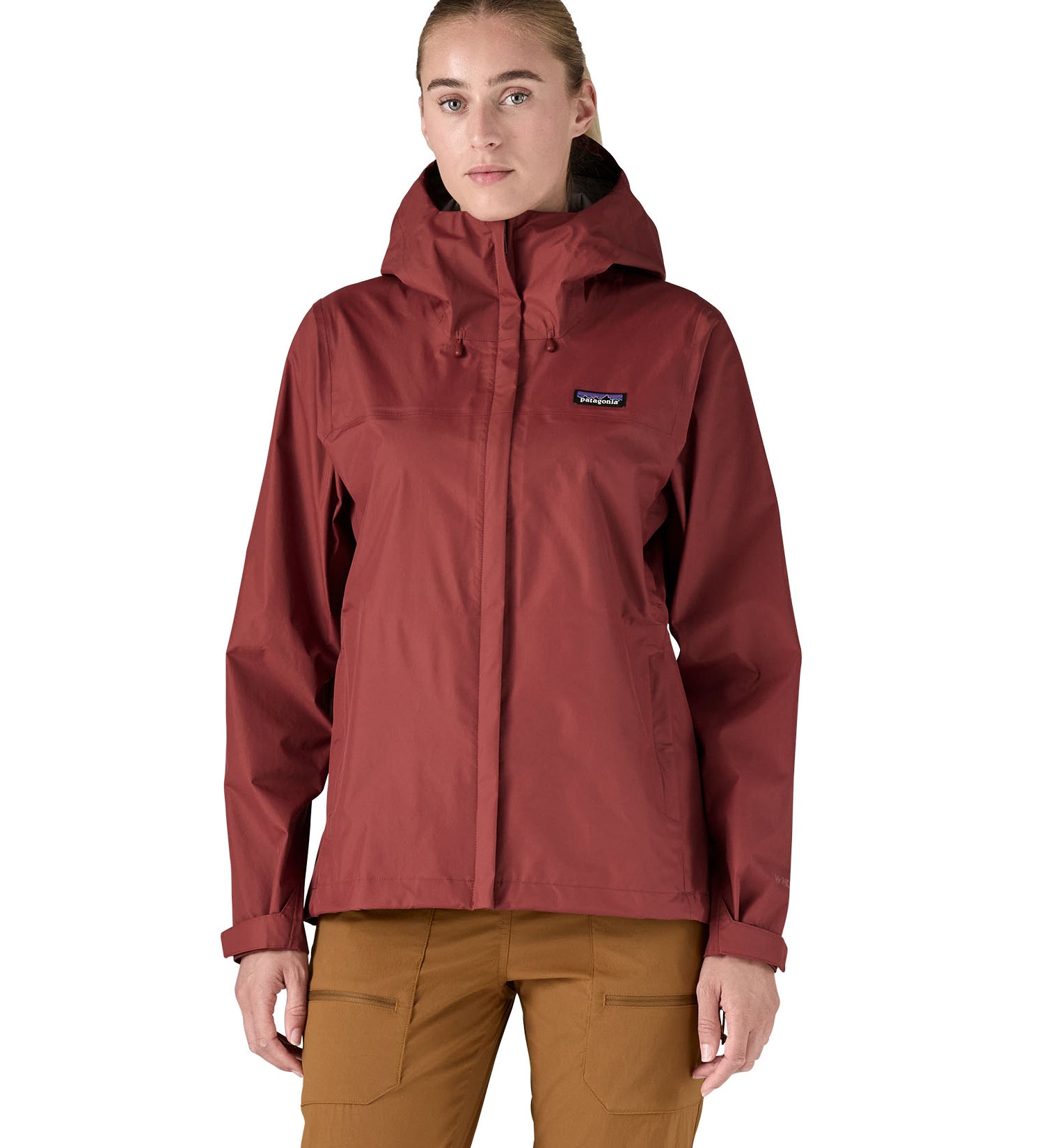 A person wearing the Patagonia Women's Torrentshell 3L Rain Jacket - Oxide Red, to show the fit of the jacket from the front