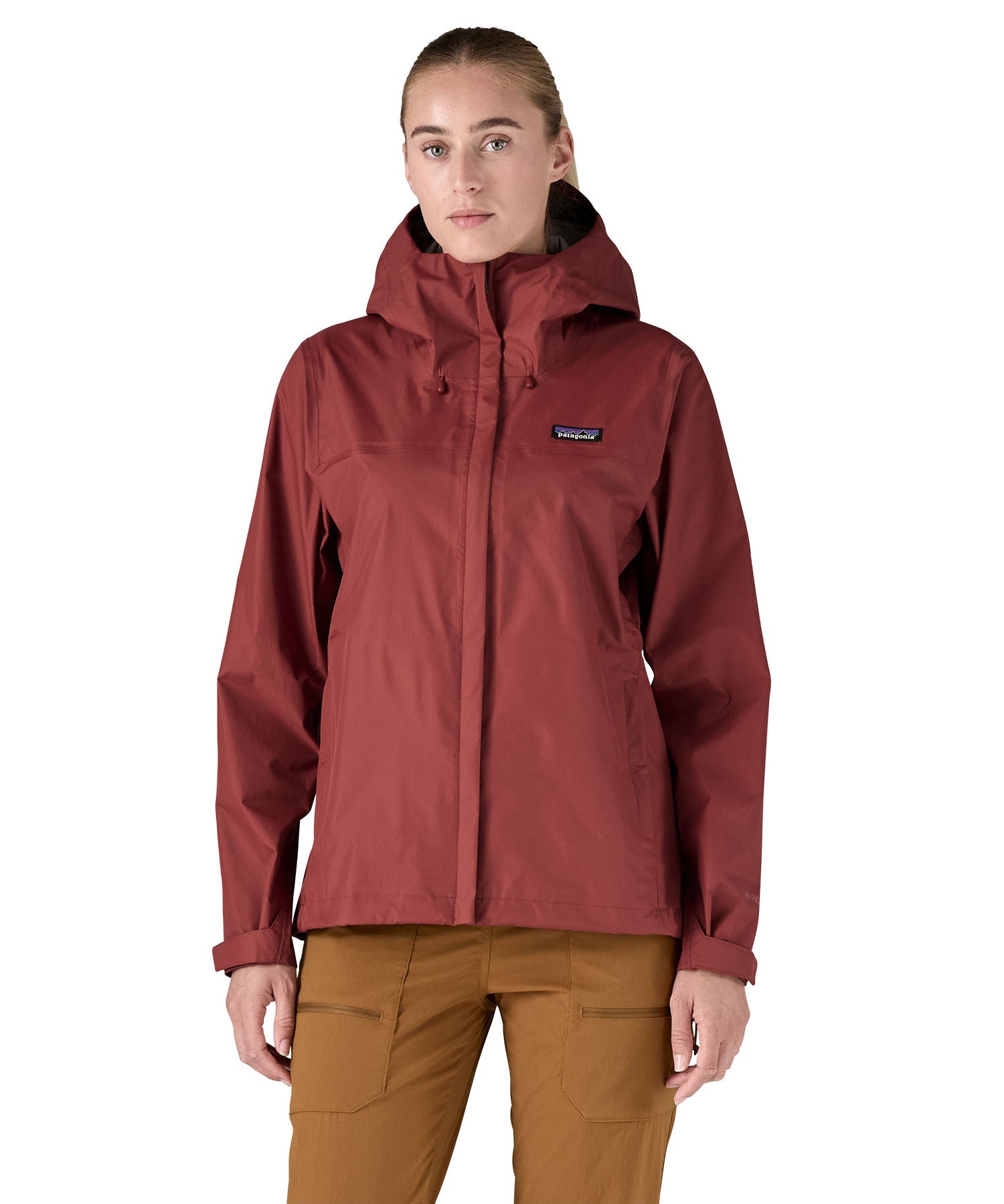 A person wearing the Patagonia Women's Torrentshell 3L Rain Jacket - Oxide Red, to show the fit of the jacket from the front