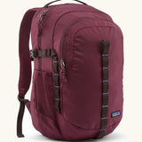 Patagonia 30L refugio backpack in maroon. Features a side bottle holder and brown gear loops and quick release buckles.