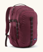 Patagonia 30L refugio backpack in maroon. Features a side bottle holder and brown gear loops and quick release buckles.