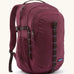 Patagonia 30L refugio backpack in maroon. Features a side bottle holder and brown gear loops and quick release buckles.