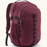 Patagonia 30L refugio backpack in maroon. Features a side bottle holder and brown gear loops and quick release buckles.