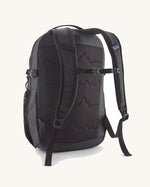 Back of the Patagonia 26L refugio backpack in black with a chest strap and quick release buckle.