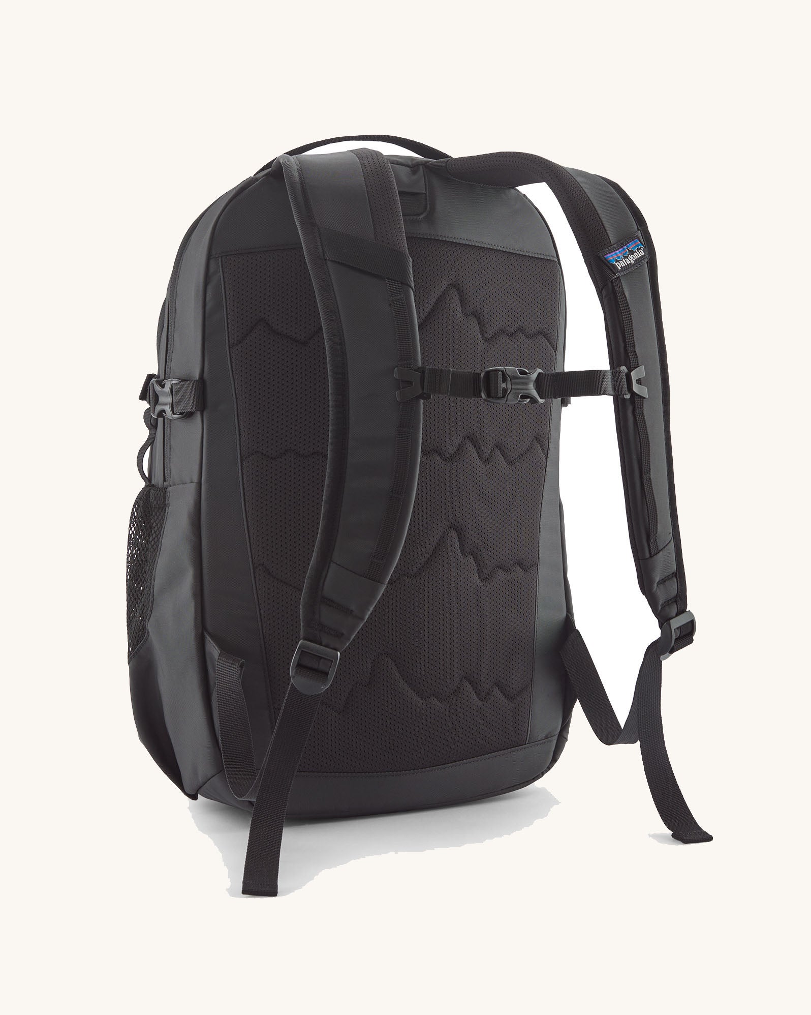 Back of the Patagonia 26L refugio backpack in black with a chest strap and quick release buckle.