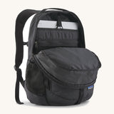 Patagonia refugio 26L back pack in black with the main compartment open and a laptop in the sleeve at the back.