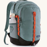 Patagonia refugio backpack insage blue with a bottle in the side mesh holder.
