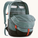 Patagonia refugio 26L back pack in sage blue with the main compartment open and a laptop in the sleeve at the back.