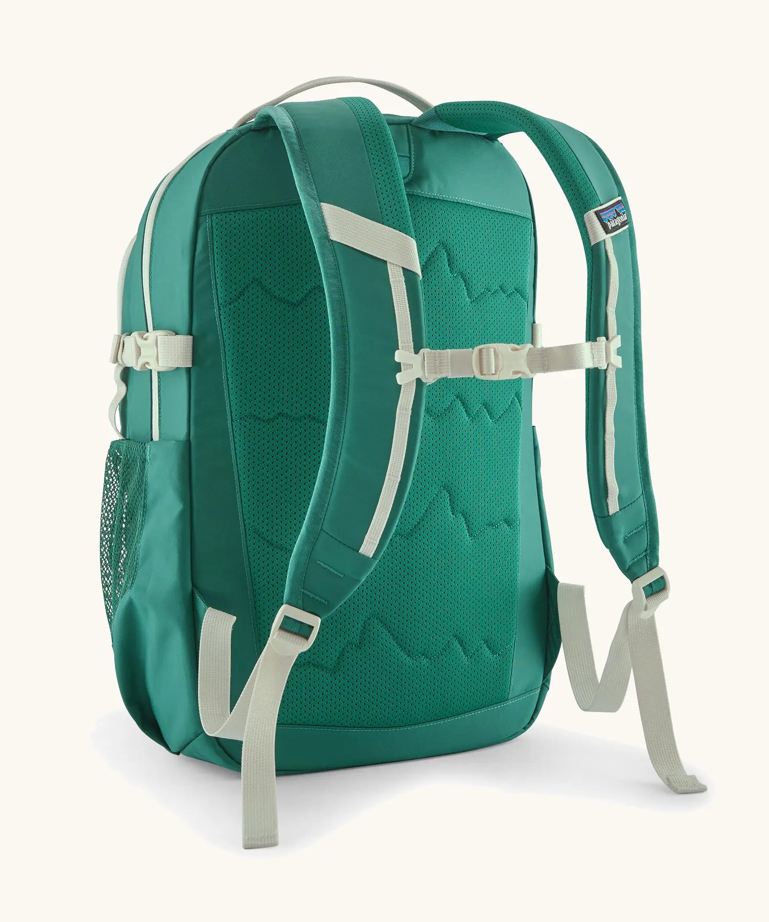 Back of the Patagonia 26L refugio backpack in green with a chest strap and quick release buckle.