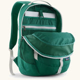 Patagonia refugio 26L back pack in green with the main compartment open and a laptop in the sleeve at the back.