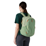 The back of a woman wearing the Patagonia refugito day pack 26 litres in lichen green available at Babipur showing the mesh side pocket detail