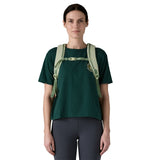 A woman wearing the Patagonia refugito day pack 26 litres in lichen green available at Babipur showing the chest strap detail