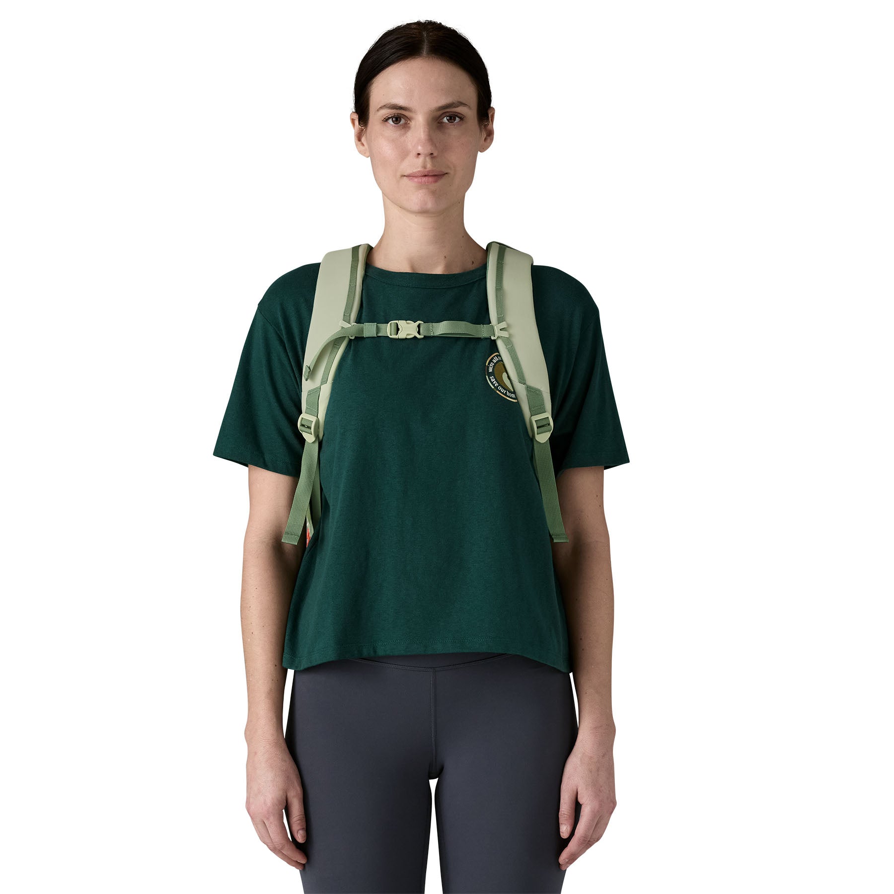 A woman wearing the Patagonia refugito day pack 26 litres in lichen green available at Babipur showing the chest strap detail