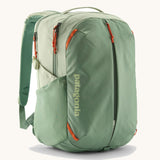 Patagonia refugito day pack 26 litres in lichen green. A 100% recycled material backpack in pastel green with orange detail. Features padded shoulder straps, mesh side pockets and 3 main compartments. 