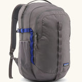 Patagonia 30L refugio backpack in grey. Features a side bottle holder and blue and grey gear loops and quick release buckles.