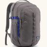 Patagonia 30L refugio backpack in grey. Features a side bottle holder and blue and grey gear loops and quick release buckles.