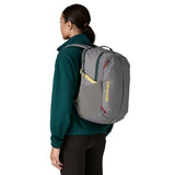 The back of a woman wearing the Patagonia refugito day pack 26 litres in noble grey available at Babipur showing the mesh side pocket detail