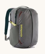 Patagonia refugito day pack 26 litres in noble grey. A 100% recycled material backpack in grey with yellow, green and brwon detail. Features padded shoulder straps, mesh side pockets and 3 main compartments. 
