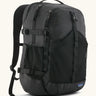 Patagonia 30L refugio backpack in black with side bottle holder and black gear loops and quick release buckles.