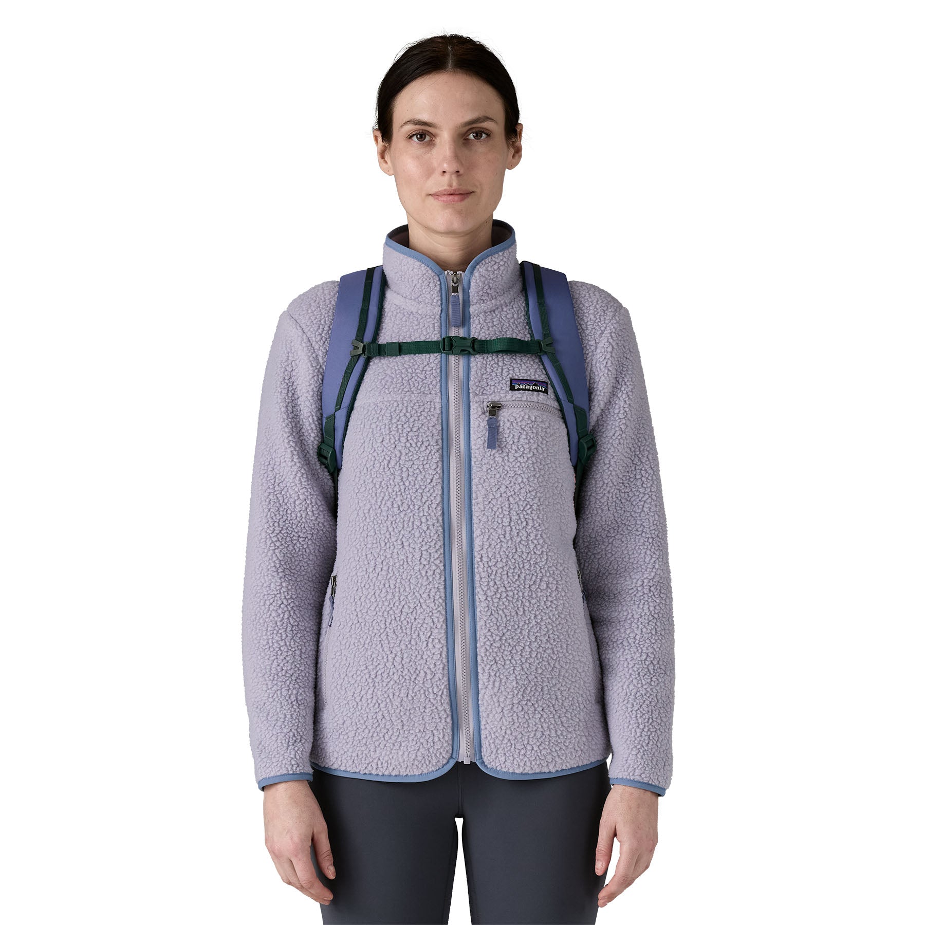 A woman wearing the Patagonia refugio 30 litres day pack in current blue available at Babipur showing the chest strap detail. 