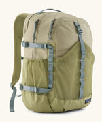 Patagonia 30L refugio backpack in light green with side bottle holder and grey gear loops and quick release buckles.