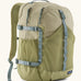 Patagonia 30L refugio backpack in light green with side bottle holder and grey gear loops and quick release buckles.