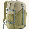 Patagonia 30L refugio backpack in light green with side bottle holder and grey gear loops and quick release buckles.