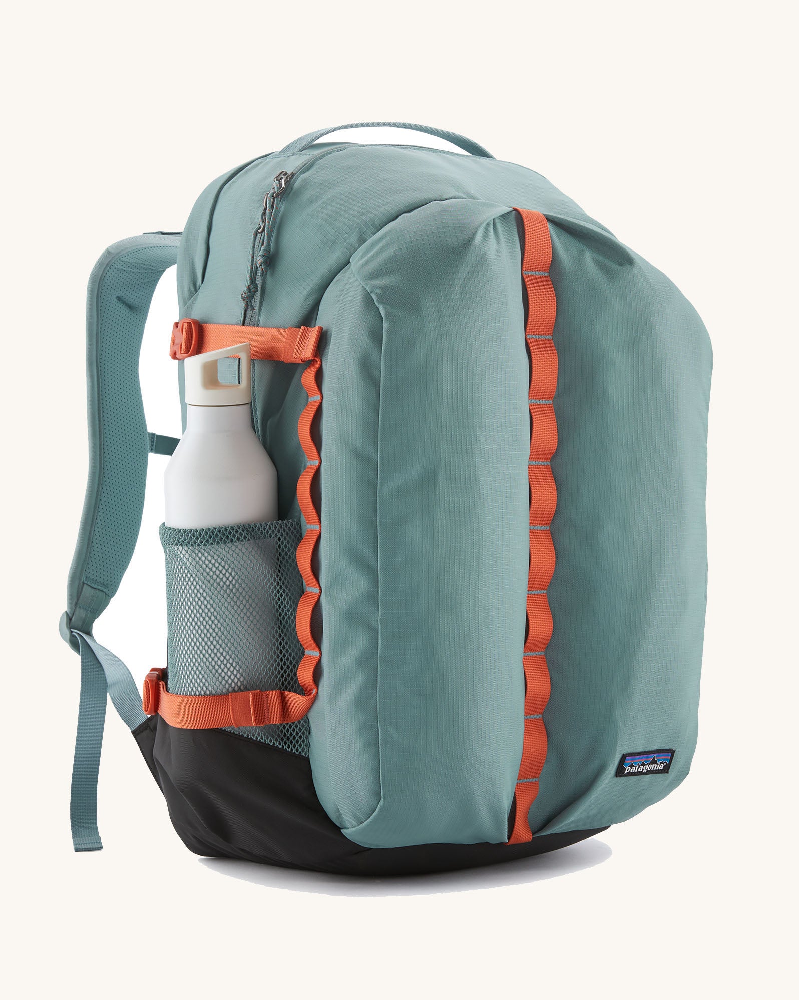 Patagonia refugio 32L daypack in sage blue and orange trim. Shows a water bottle mesh side pockets 