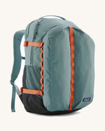 Patagonia refugio 32L daypack in sage blue and orange trim. Shows mesh side pockets and zipped compartment. 