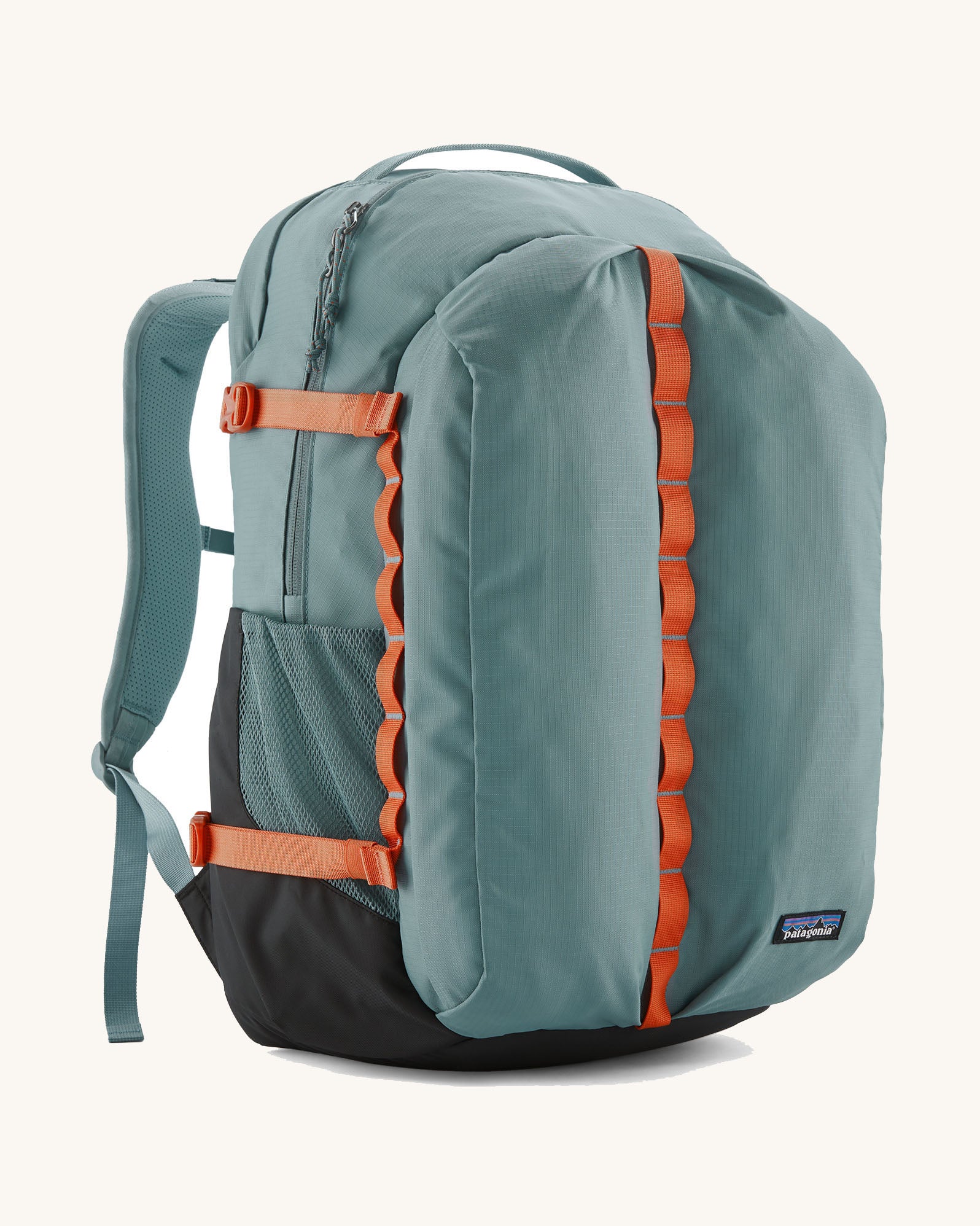 Patagonia refugio 32L daypack in sage blue and orange trim. Shows mesh side pockets and zipped compartment. 