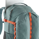 Close up of a laptop inside a zipped compartment of the Patagonia's refugio 32L daypack in sage blue 