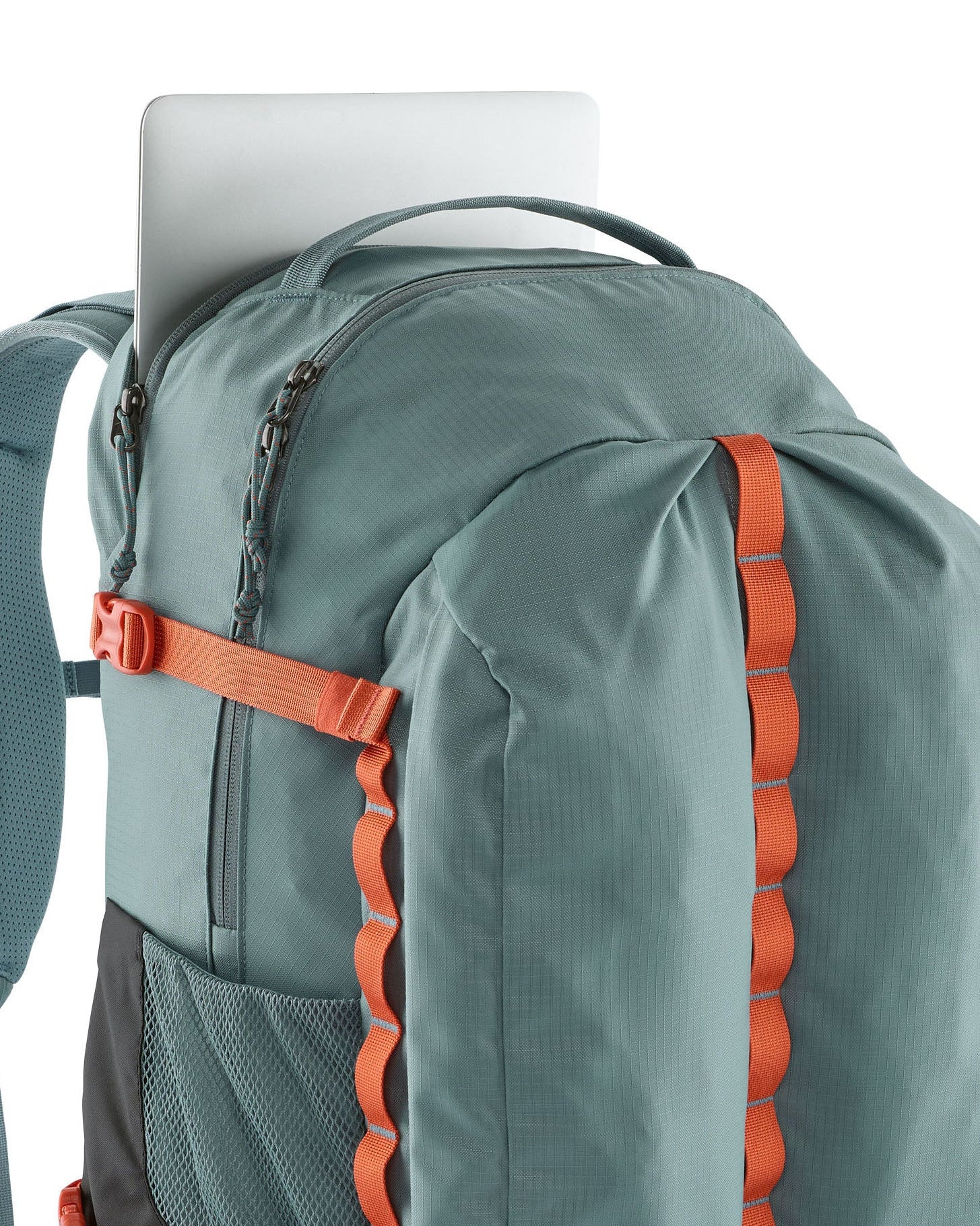 Close up of a laptop inside a zipped compartment of the Patagonia's refugio 32L daypack in sage blue 