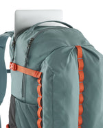 Close up of a laptop inside a zipped compartment of the Patagonia's refugio 32L daypack in sage blue 