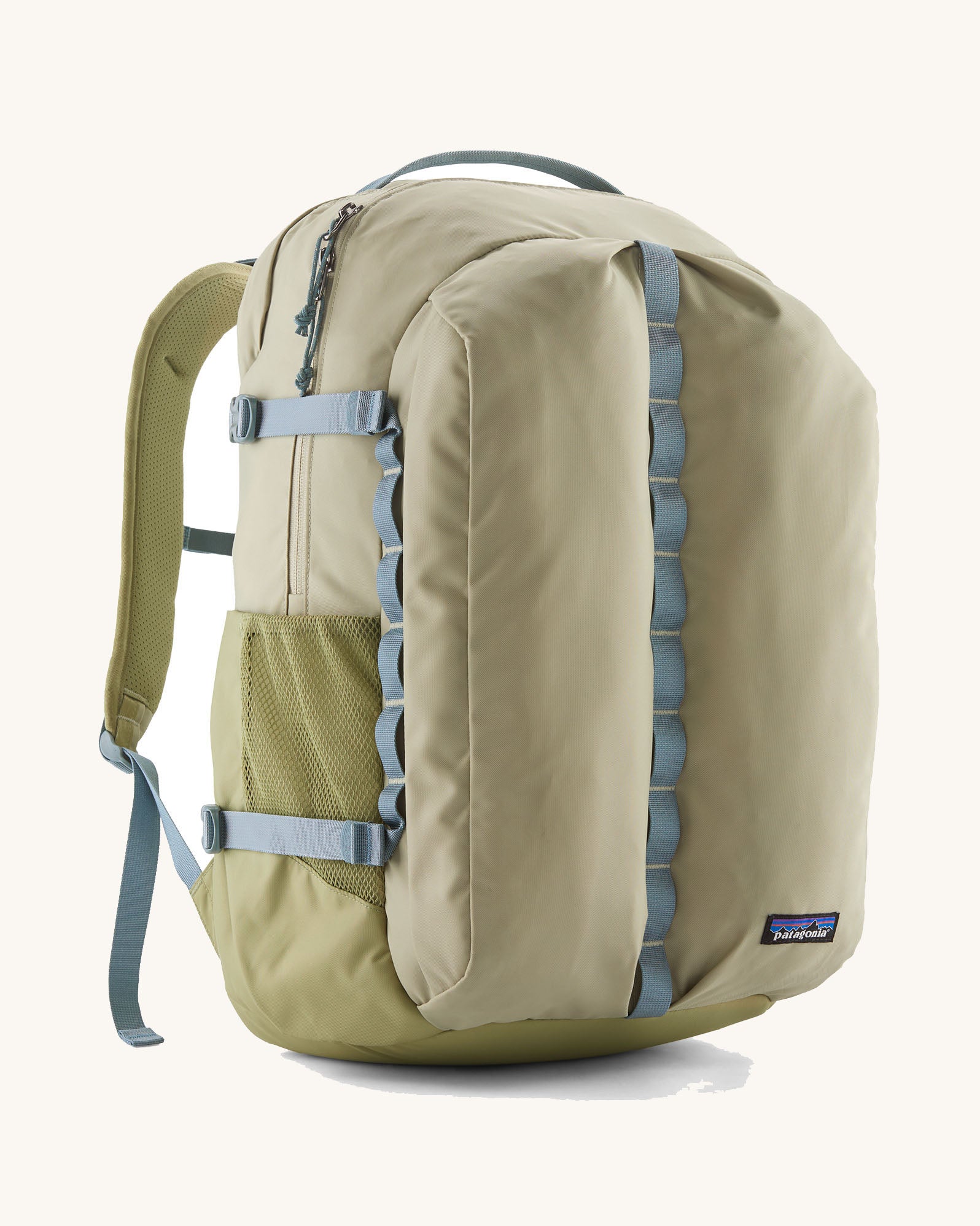 Patagonia refugio 32L daypack in light green and blue trim. Shows mesh side pockets and zipped compartment. 