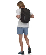 A person wearing the Patagonia Refugio Day Pack 30L Black, showing the back pack from the front