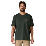 A man wearing the Patagonia men's  Strataspire tee in old growth green available at Babipur.