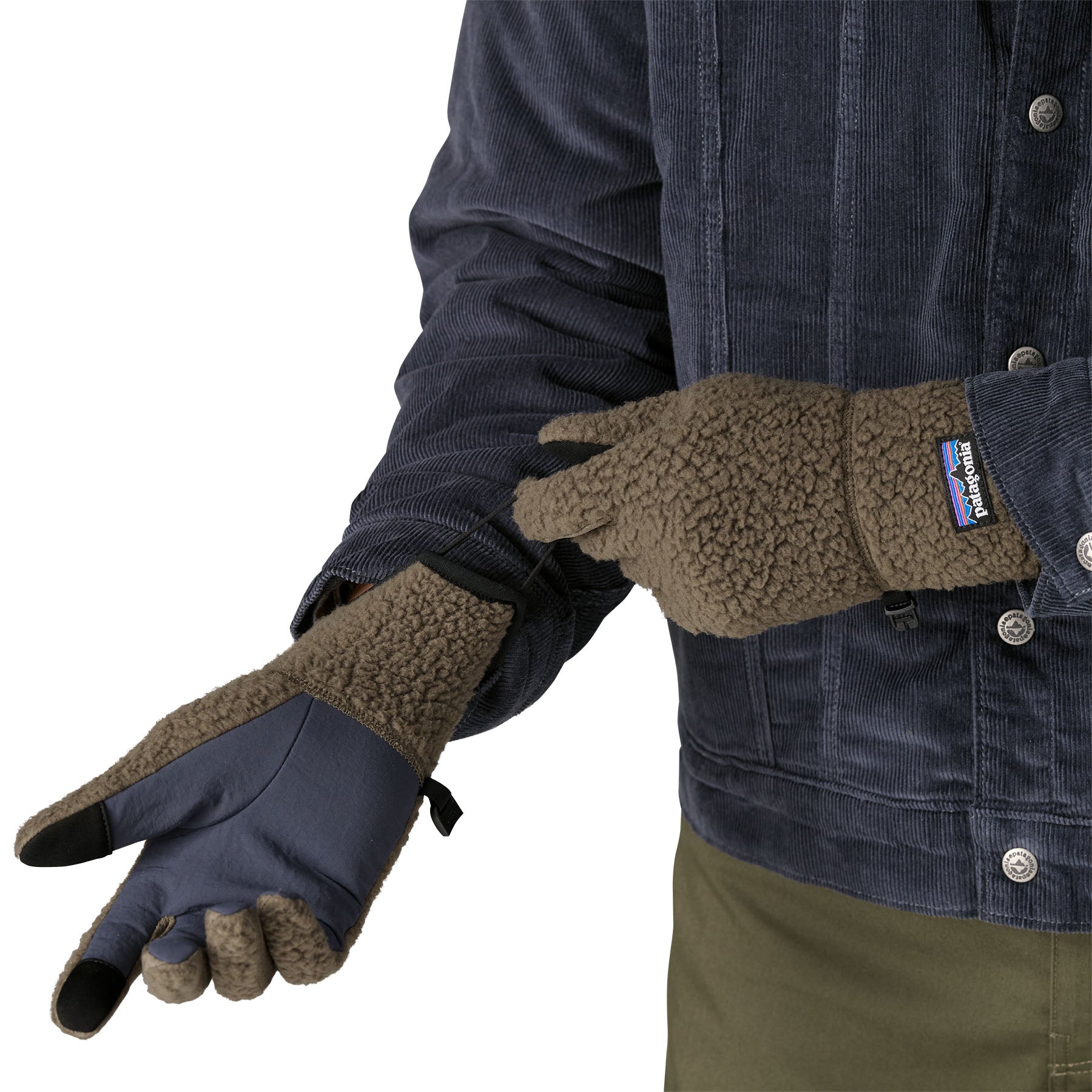 An adult putting on the Patagonia adult synchilla gloves in marlon brown available at Babipur. 