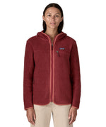 A woman wearing the A Patagonia Women's Retro Pile Fleece Hoody Jacket in the Sequoia Red colour way available at Babipur. The dark burgundy red, zipped, hooded ladies fleece has handy zipped pockets.