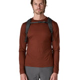  A man wearing the Patagonia smolder  blue 24L atom day pack available at Babipur.