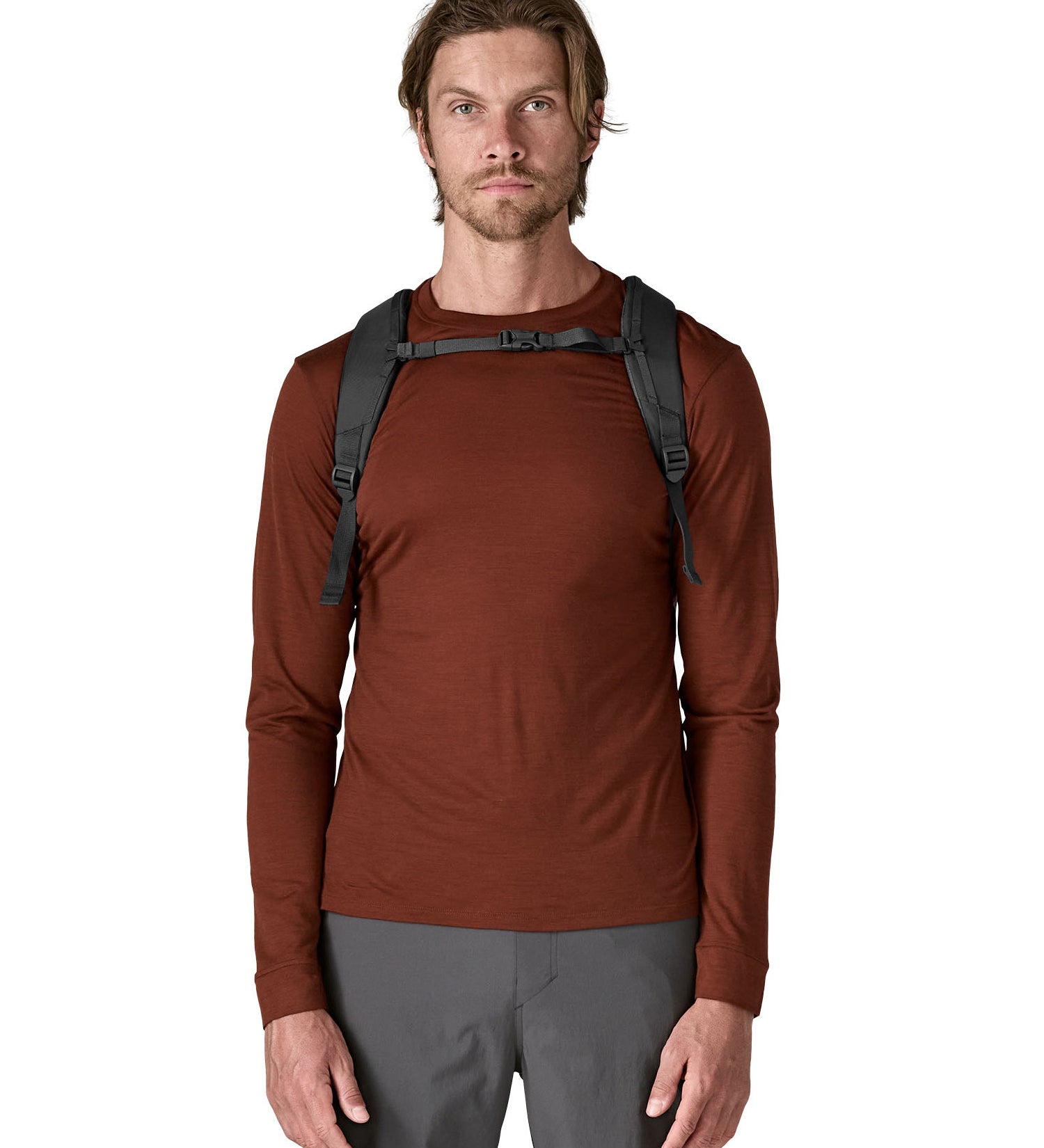 A man wearing the Patagonia smolder  blue 24L atom day pack available at Babipur.